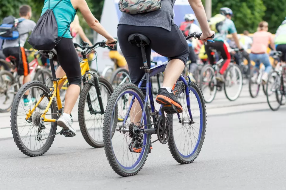 Large group of cyclists on city street.